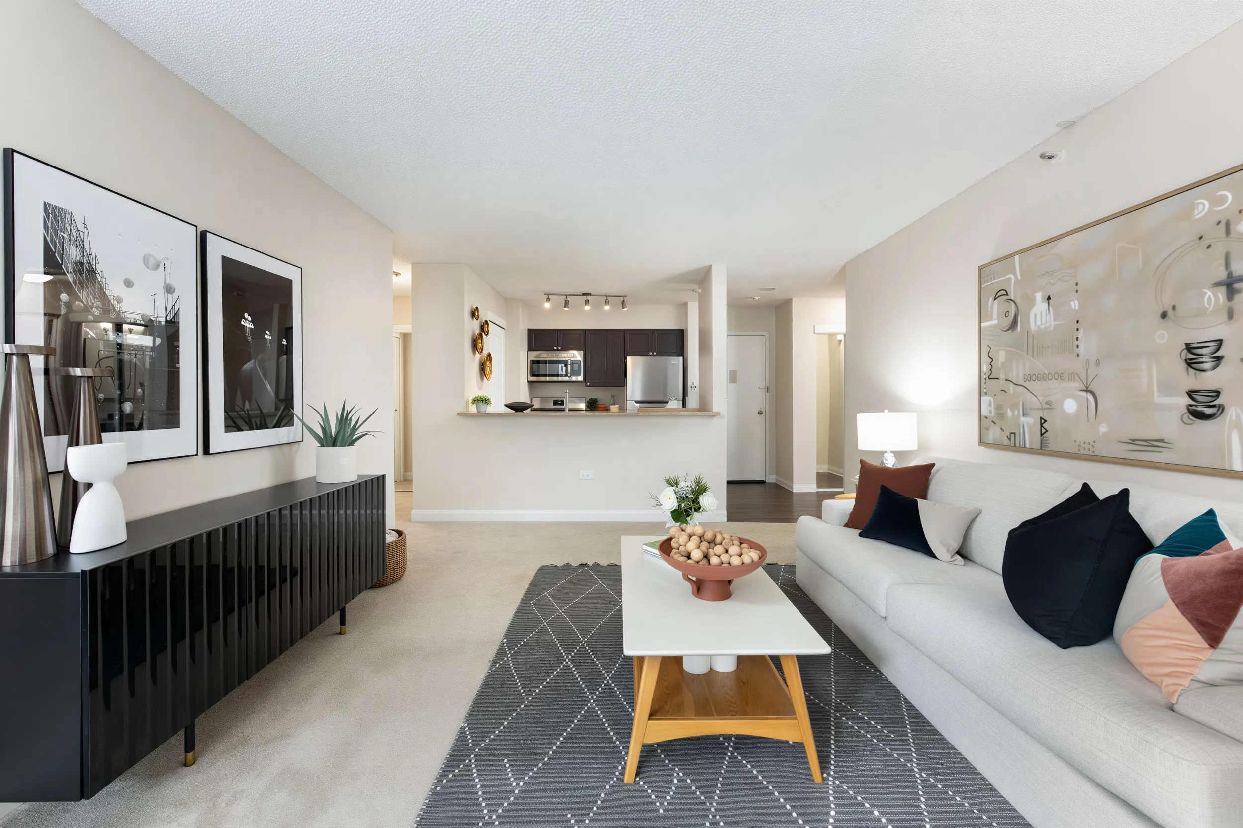 Spacious apartment living room with open kitchen and modern furnishings at 300 East 17th Apartments