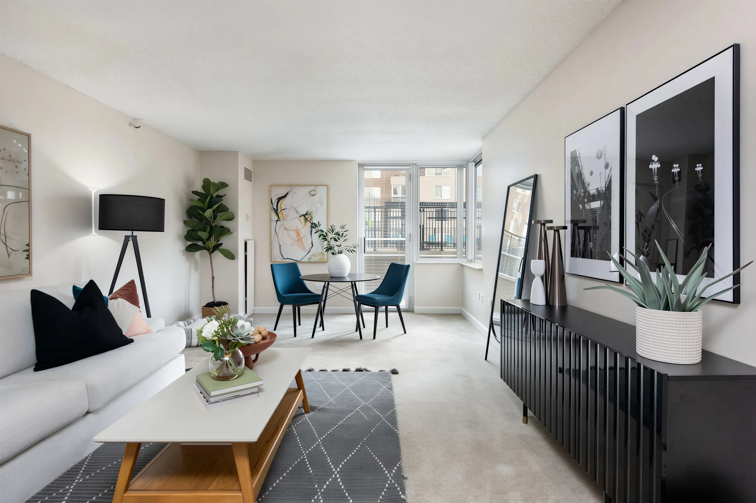Bright apartment living and dining area with large windows at 300 East 17th Apartments in Denver